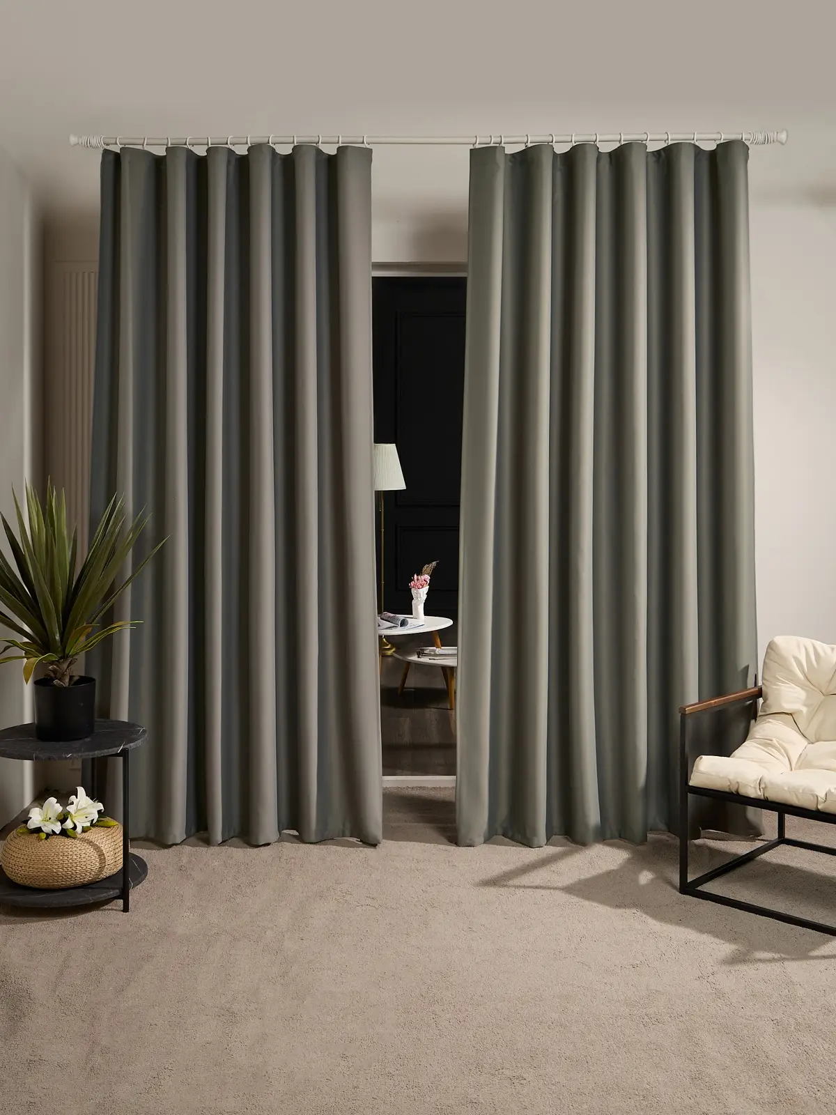 Floor-length grey curtains in a furnished room